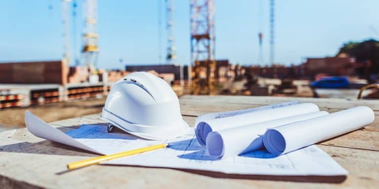 Hard Hat and Floor Plans at Construction Site